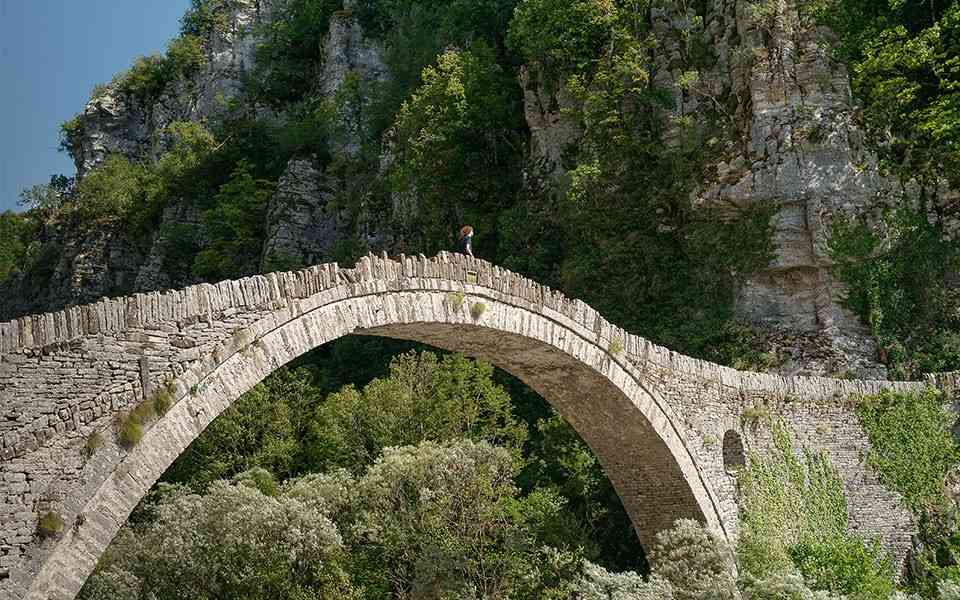 man walking on a bridge
