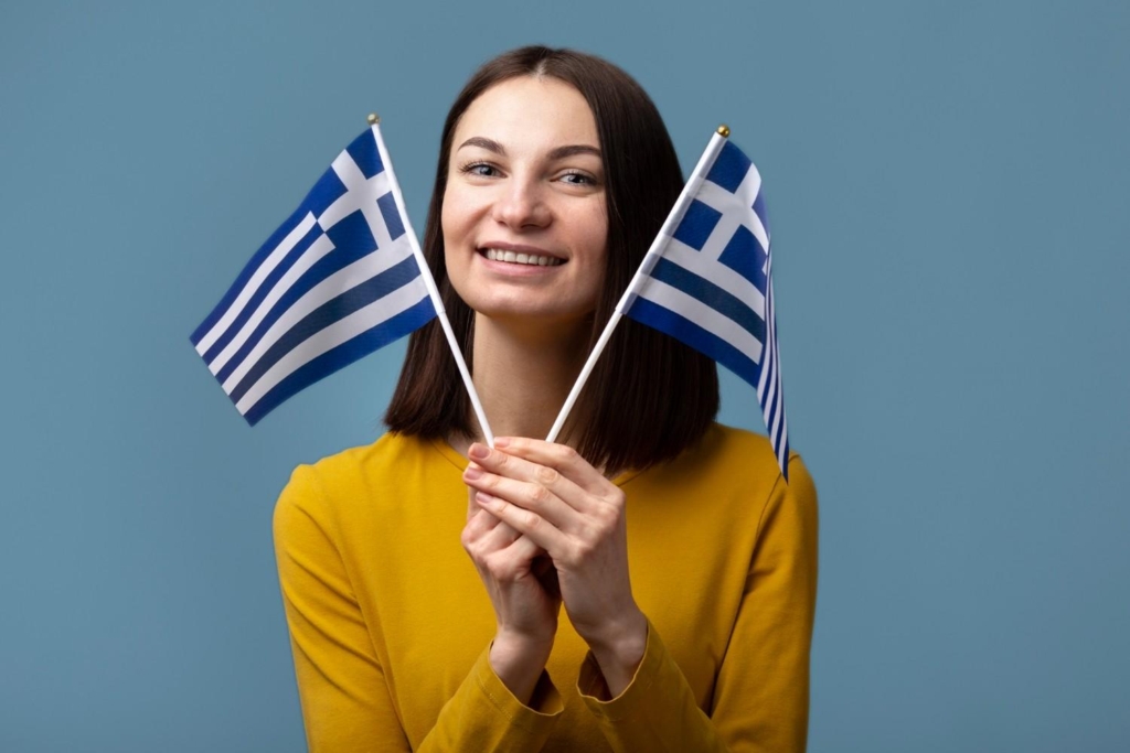 woman holding greece flags