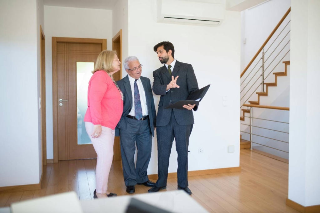 real estate agent showing a home to international property buyers