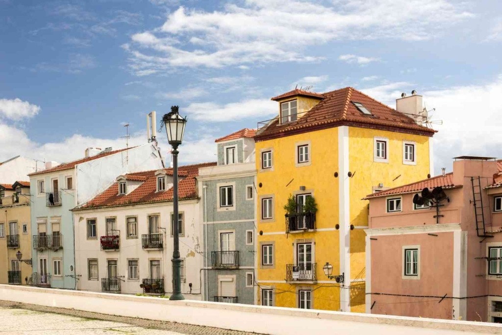 colorful residential buildings in lisbon, representing homes involved in the property buying process in portugal.