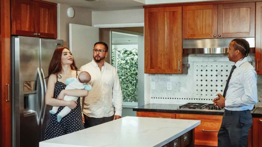 young family touring a kitchen with an agent as international property buyers