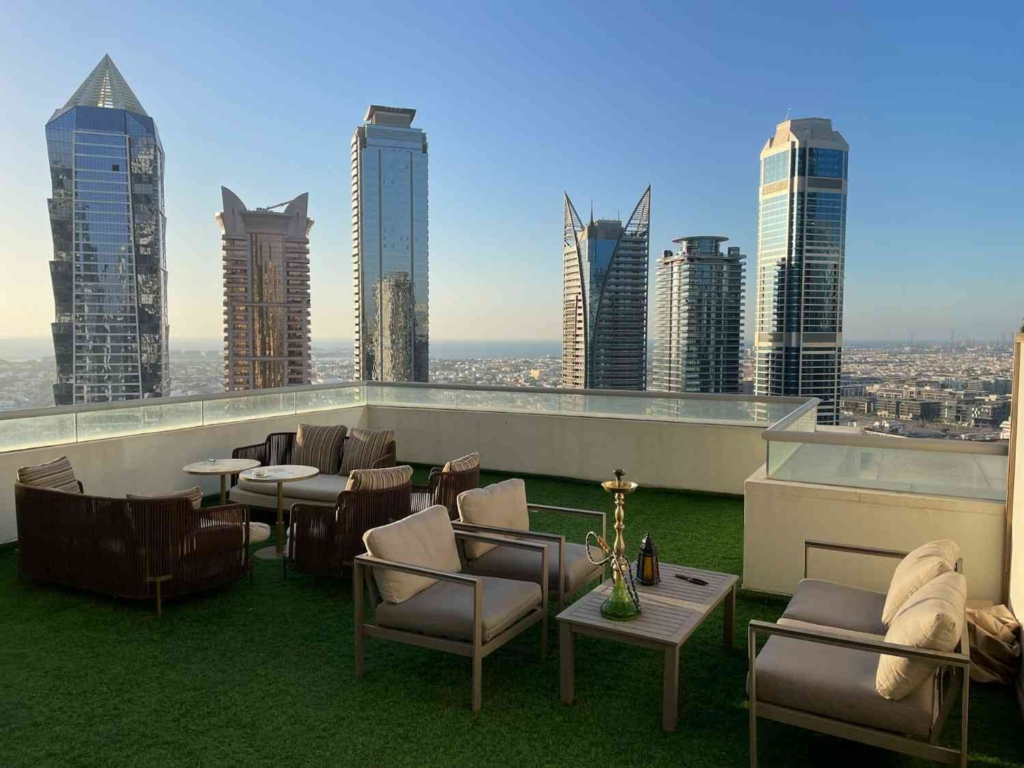 rooftop lounge with dubai skyscrapers for buying investment property in dubai.