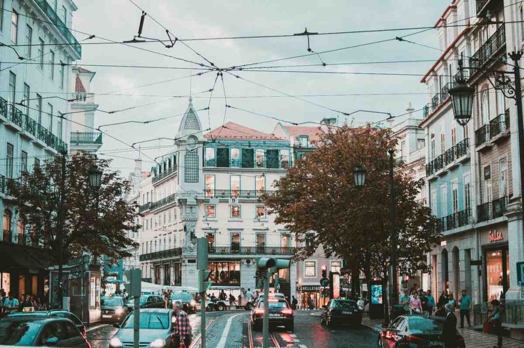 busy street in lisbon, showing neighborhoods often considered when buying property in [ortugal for foreigners.