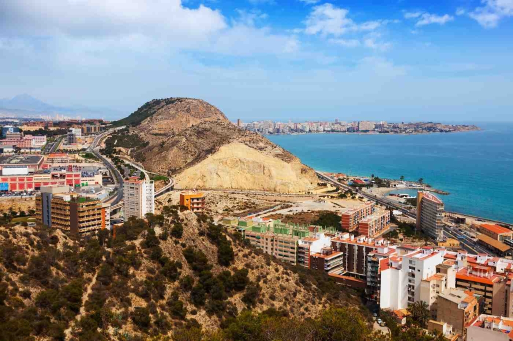 coastal city landscape with modern buildings, ideal for houses for sale in alicante
