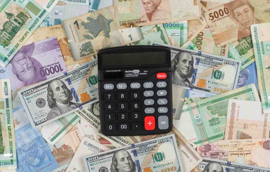 calculator and international currency notes for french retirement visa financial planning