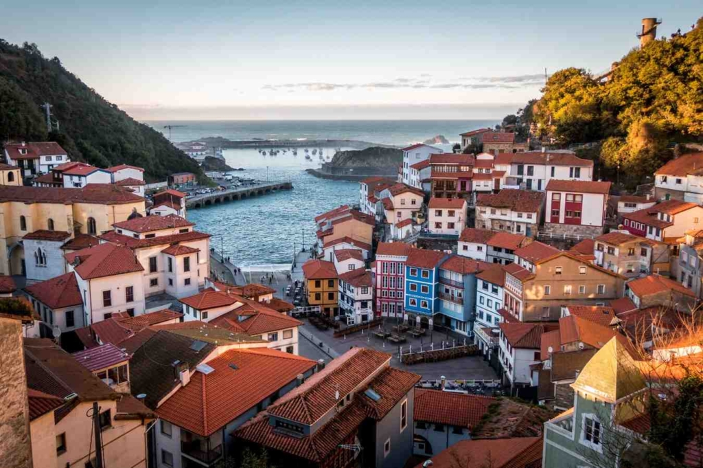 coastal village with colorful houses and harbor, perfect for property for sale in sicily, italy.