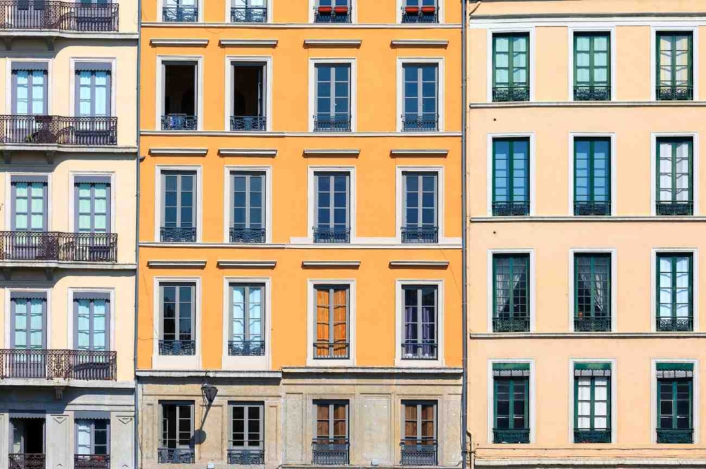colorful apartment facades in lyon, example of inexpensive places to live in france.
