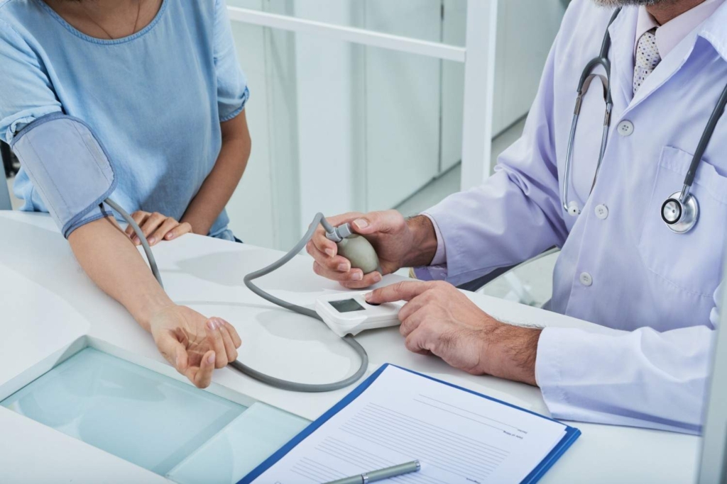 doctor checking blood pressure, healthcare planning for retirement in italy.