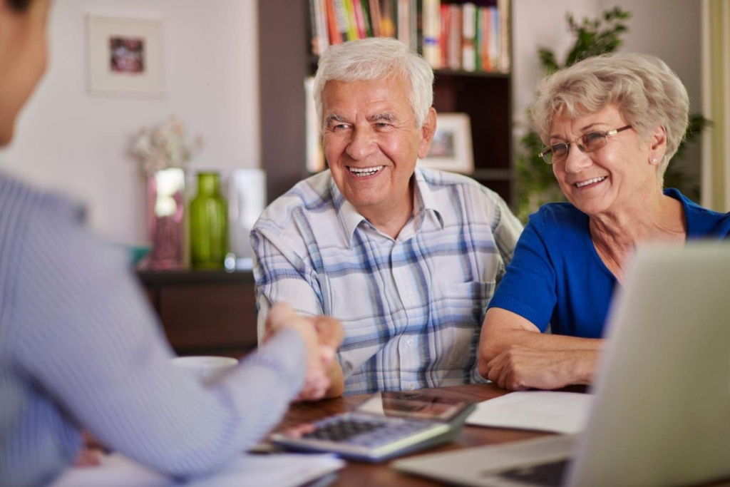 happy couple meeting advisor about retiring to france