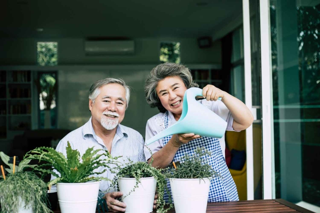 happy senior couple gardening at home, lifestyle inspiration for how to retire in france.