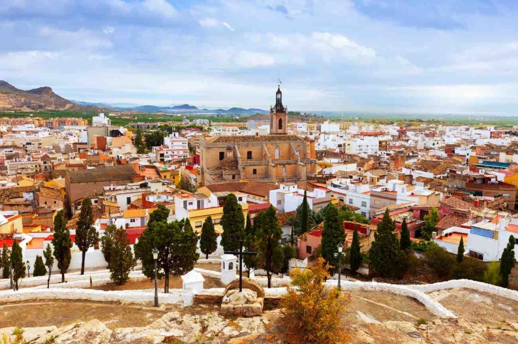 historic town with church and rooftops, ideal for property for sale in sicily, italy.
