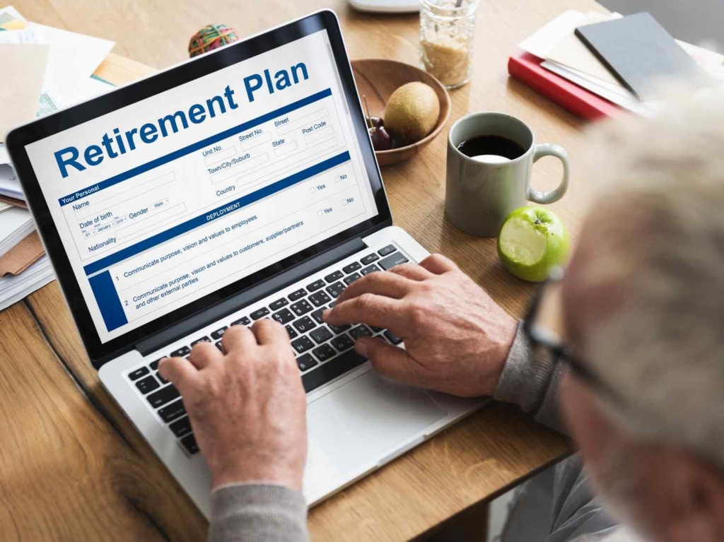 man filling retirement plan form online for french retirement visa
