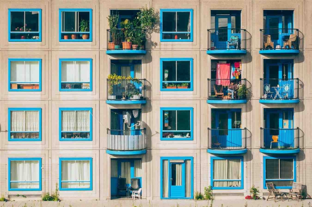 modern residential building with balconies representing spain apartments for sale in city areas