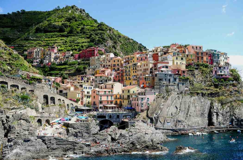 where to buy property in italy with scenic coastal views and colorful hillside homes.