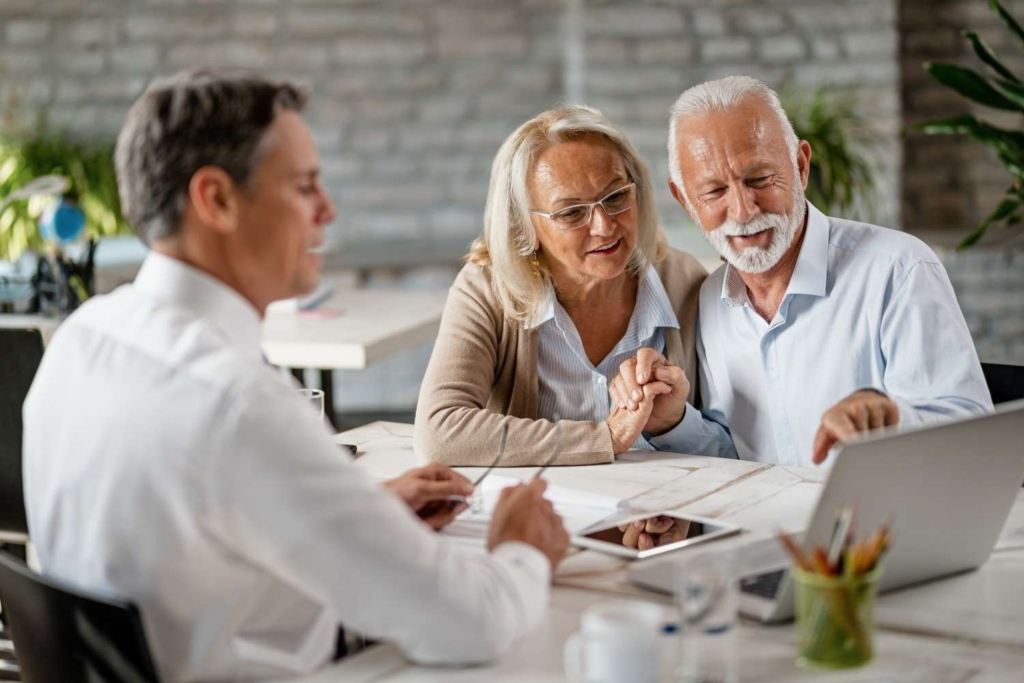 senior couple meeting advisor and planning finances for retirement in italy.