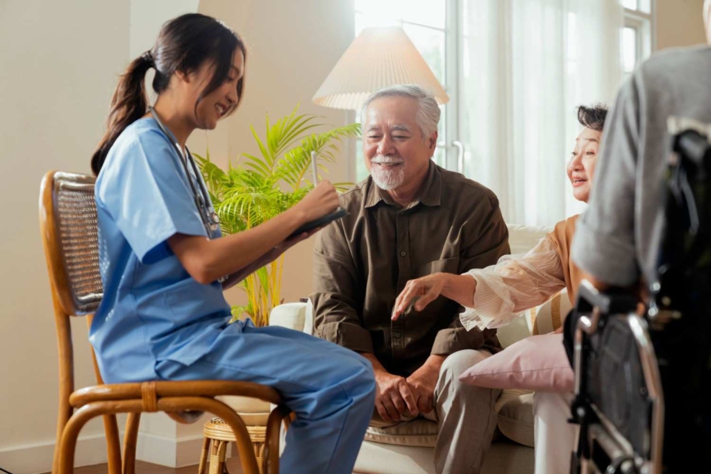 senior couple meeting caregiver indoors, planning healthcare and how to retire in france.