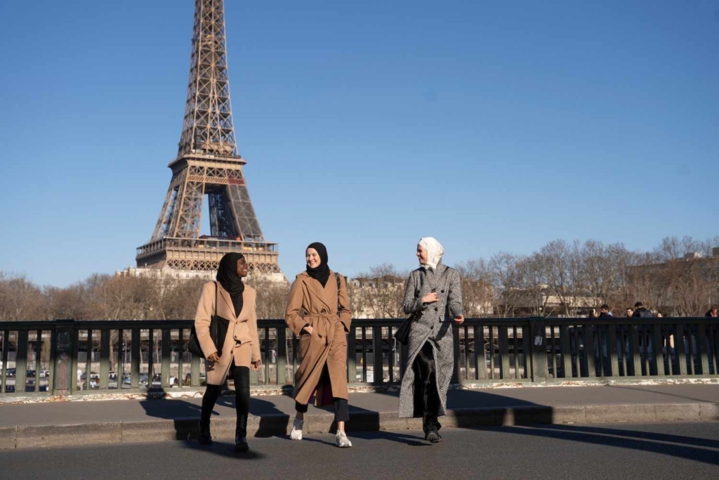 women walking near eiffel tower exploring affordable places to live in france