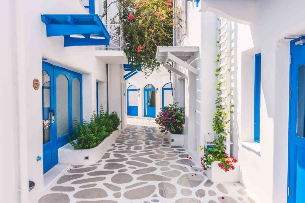 greek architecture with blue accents. how much is a house in greece?