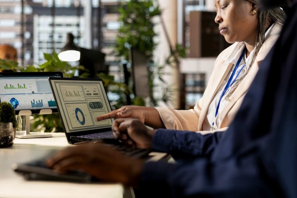 professionals reviewing property data and analytics dashboard using ai real estate services.