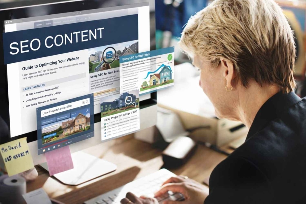 woman viewing real estate seo content on desktop screen.