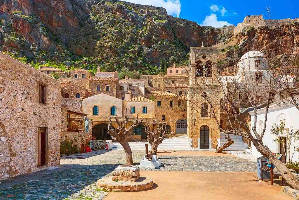 stone village square in greece showing a peaceful area that could be the cheapest place to live in greece